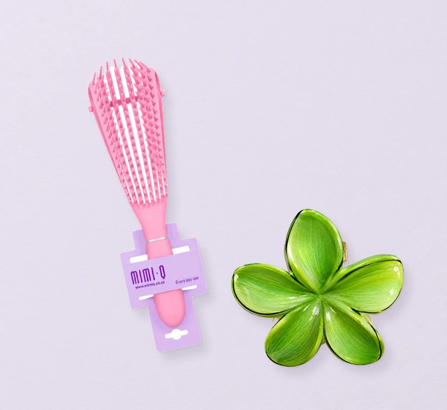 A detangling brush and a flower hair clip